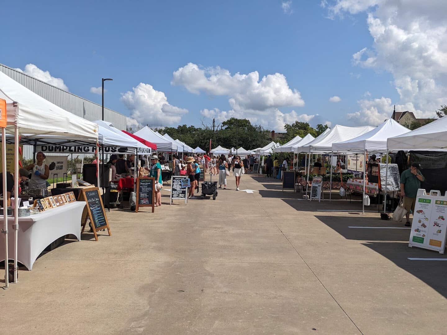Wide view of the busy Urban Harvest Farmers Market, one of the largest in Texas