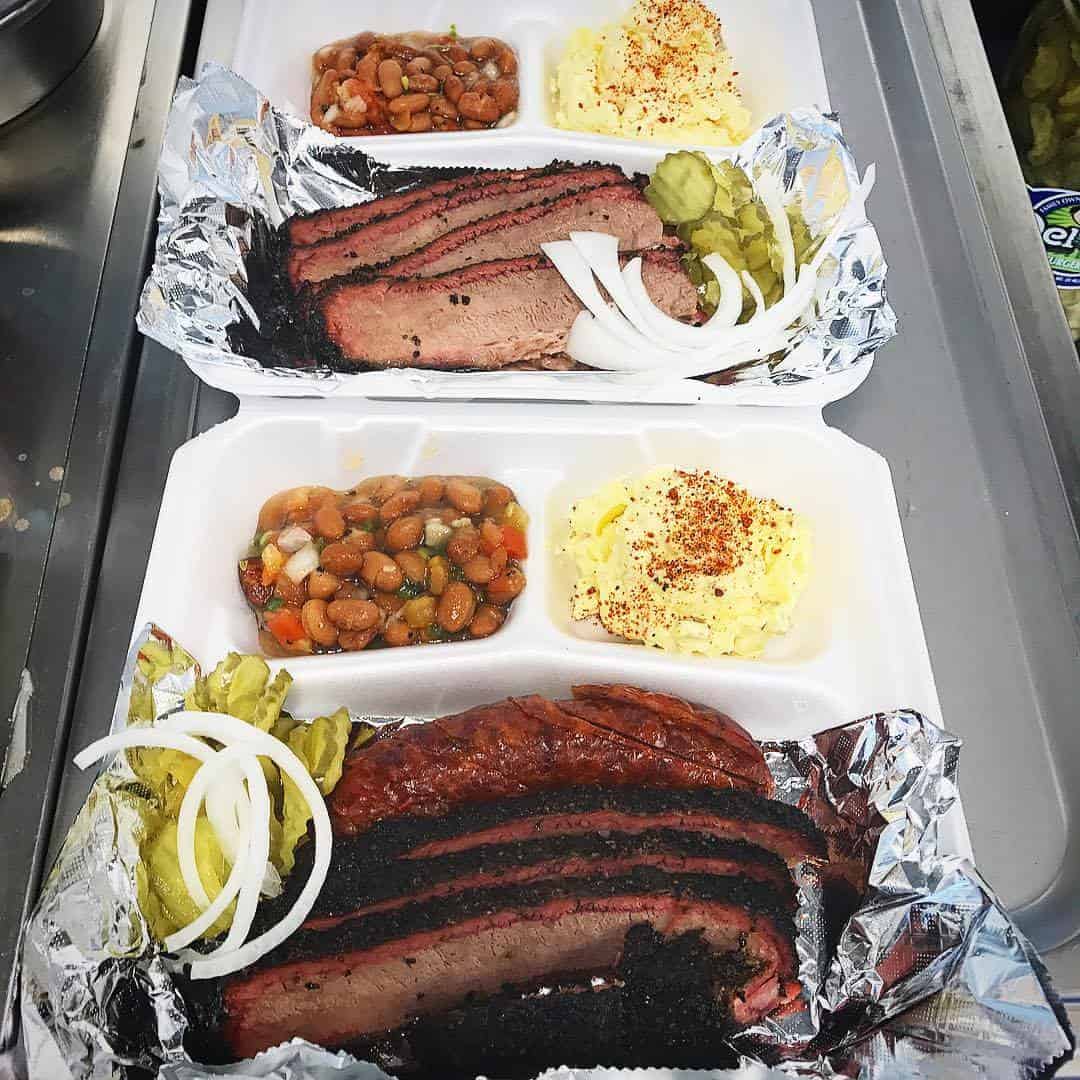 Brisket plates with beans, potato salad and pickles at Victorian's Barbecue in Mart, Texas