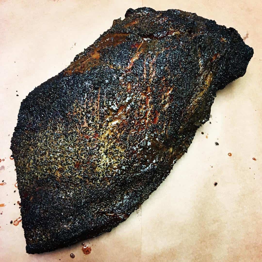 Top view of a smoked brisket with dark bark at Victorian's Barbecue in Mart, Texas