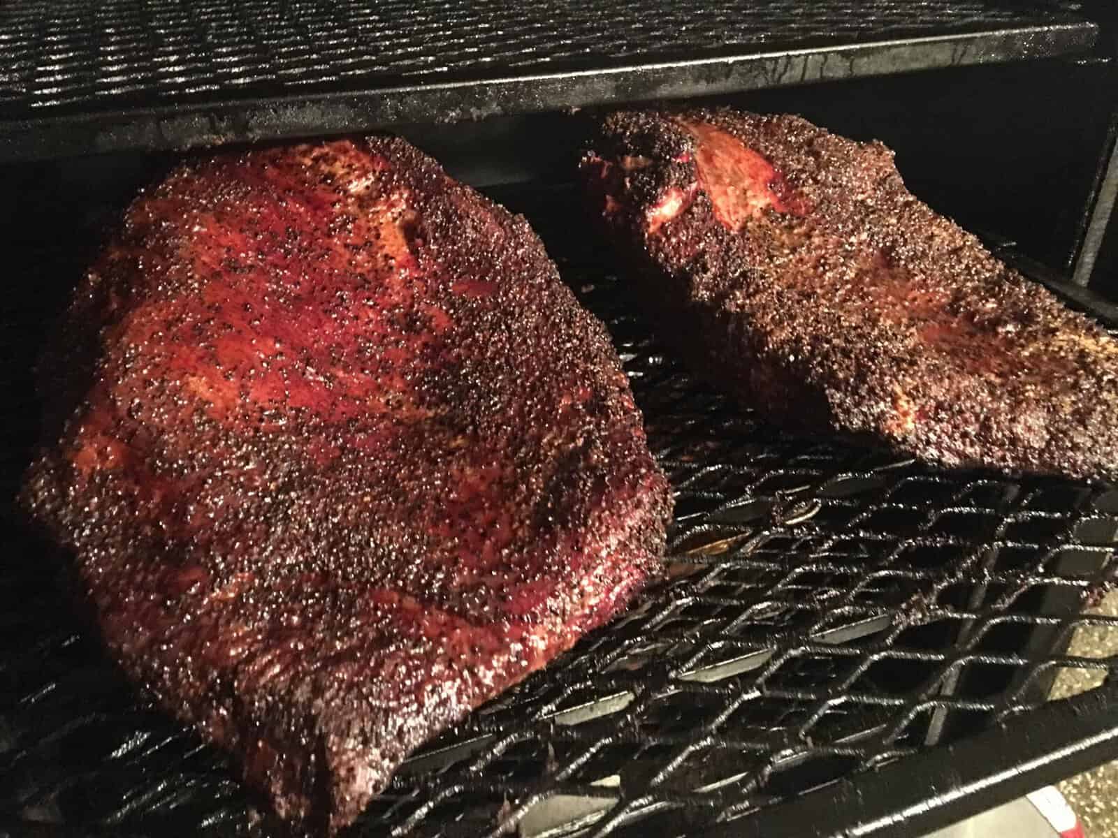 Briskets smoking on the offset pit at Victorian's Barbecue in Mart, Texas