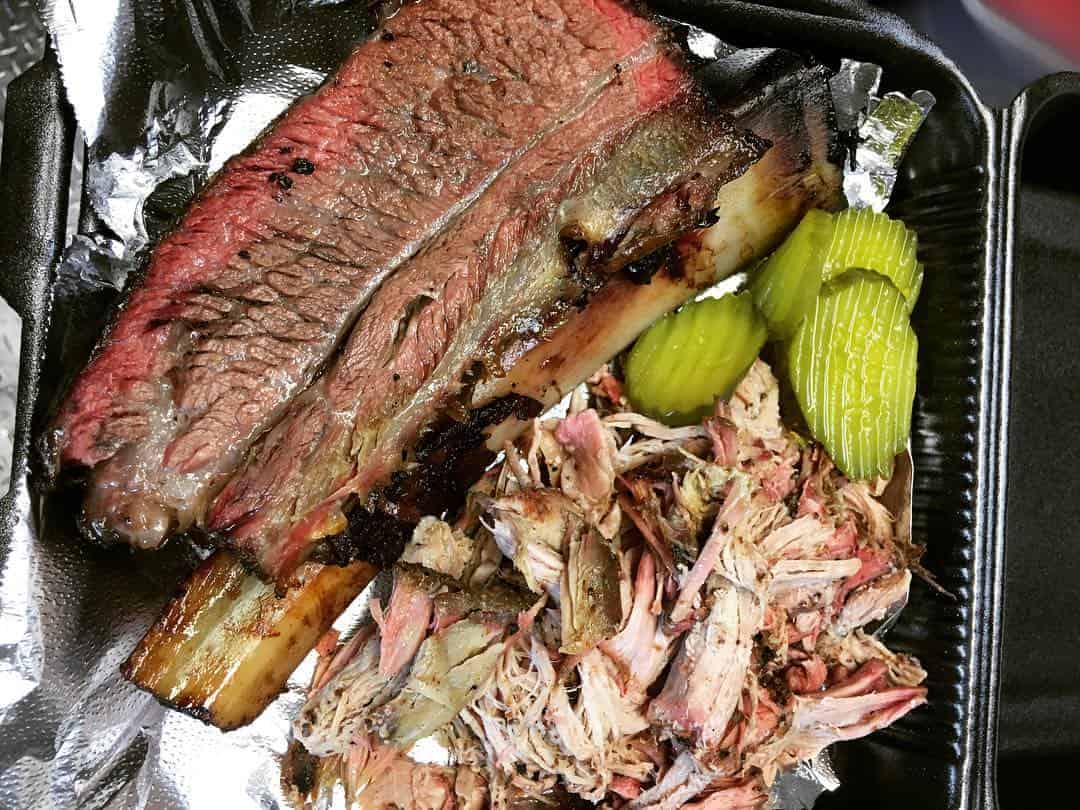 Sliced smoked brisket showing the pink smoke ring at Victorian's Barbecue in Mart, Texas