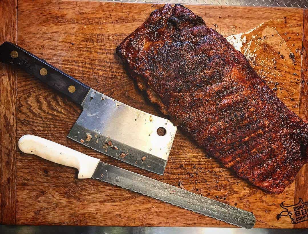 Full rack of smoked spare ribs with a cleaver at Victorian's Barbecue in Mart, Texas