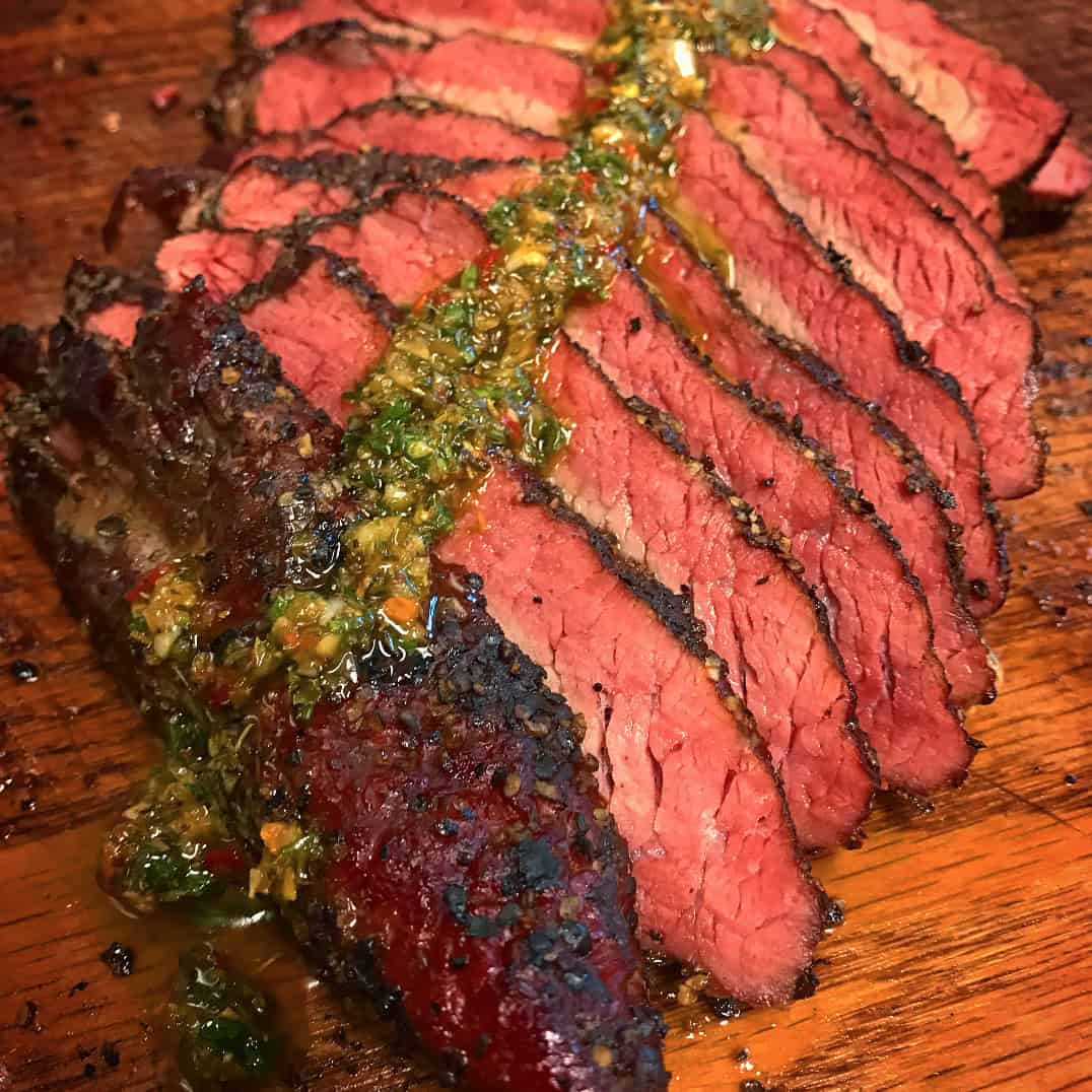 Sliced smoked tri-tip topped with chimichurri at Victorian's Barbecue in Mart, Texas