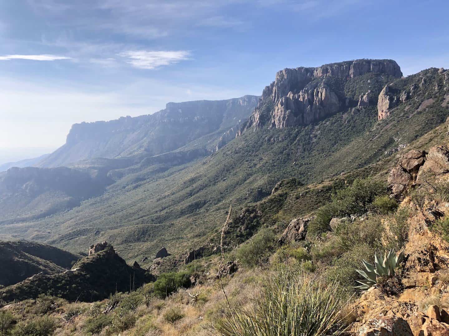 Wide view over the Chisos Basin and the desert beyond from a trail in Big Bend National Park