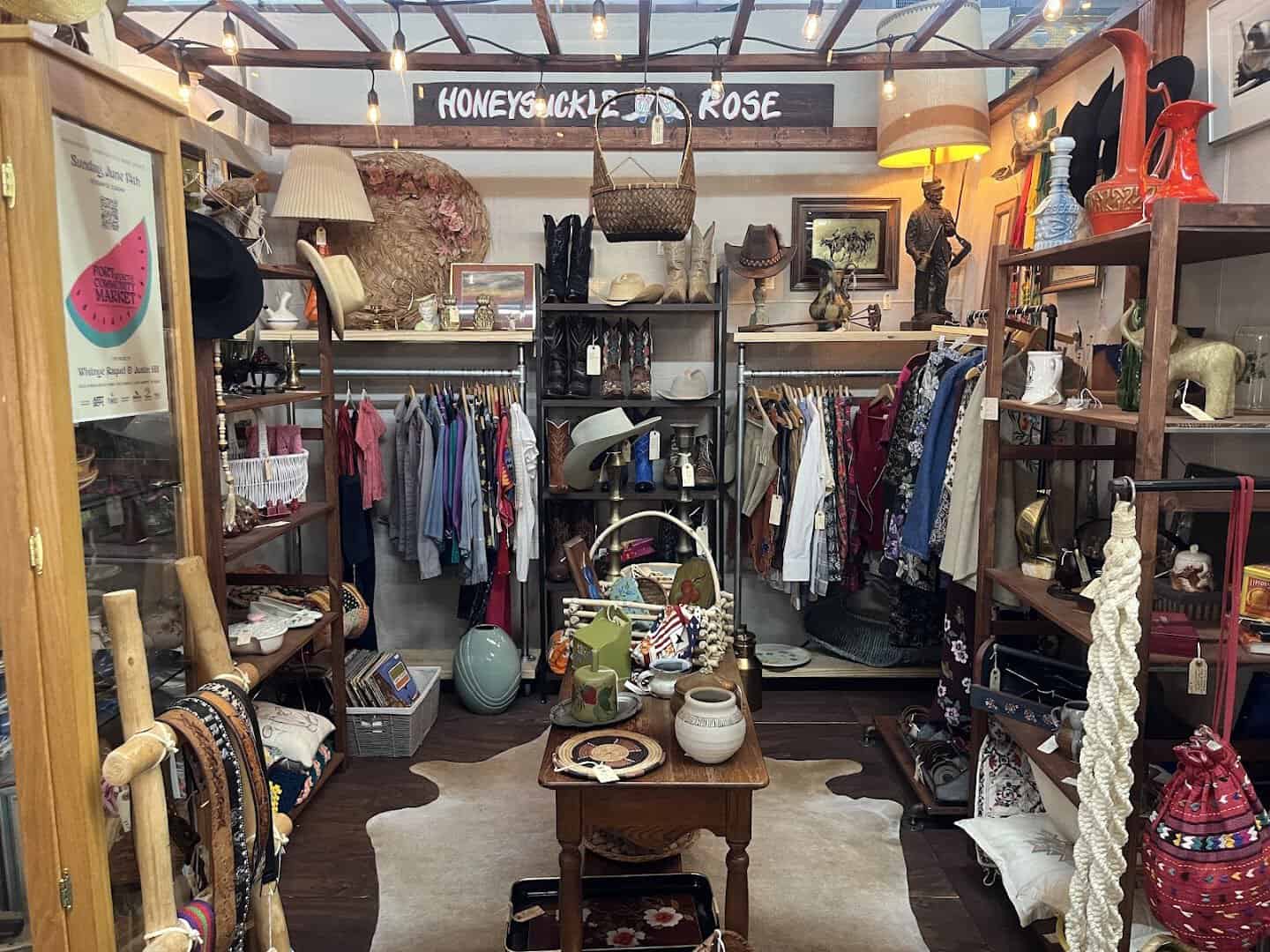 Booth of vintage clothing, lamps and decor inside a Fort Worth antique mall