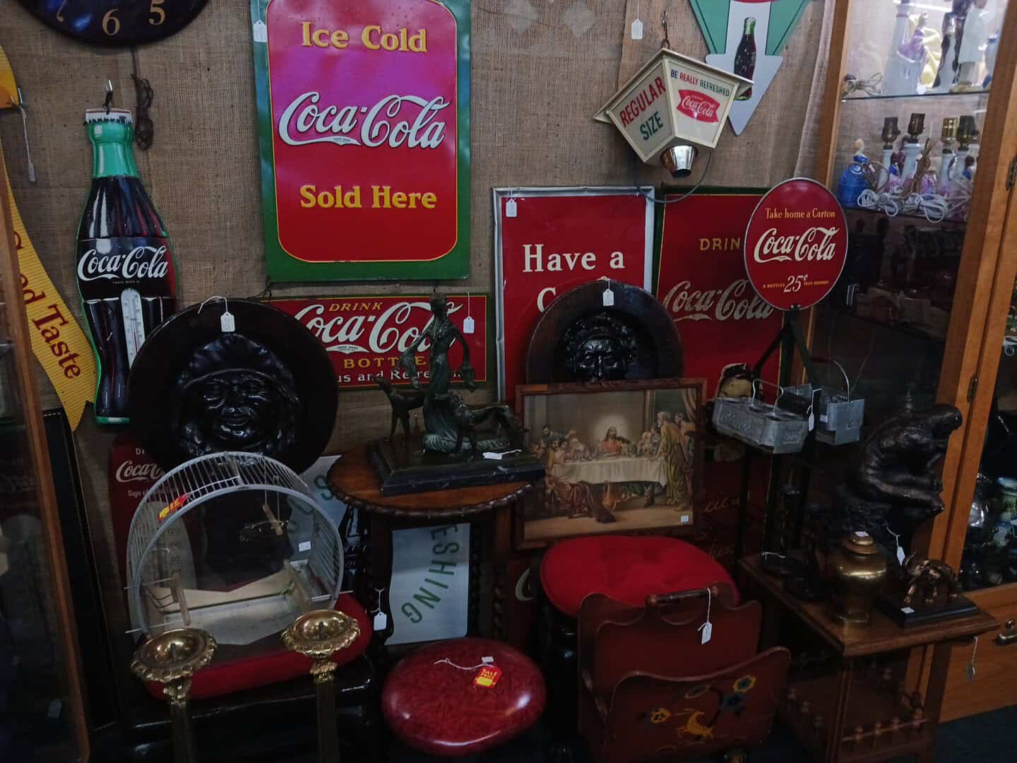 Vintage Coca-Cola signs and advertising in a booth at a Fort Worth antique mall