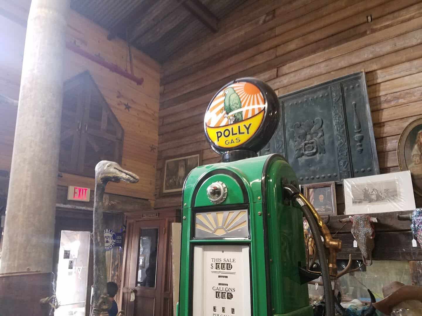 A vintage Polly Gas pump and porcelain signs at The Whoopee Bowl Antique Mall in Canutillo, Texas