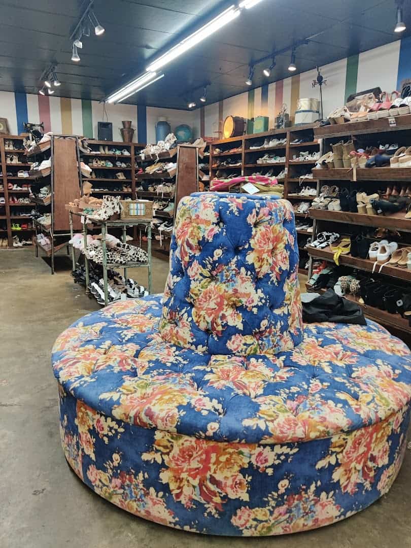 Vintage clothing racks and round seating inside Leopard Lounge in Houston