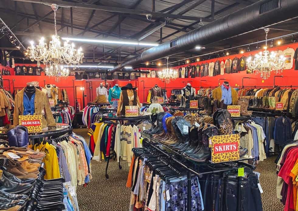 Wide view of vintage clothing racks inside Leopard Lounge in Houston