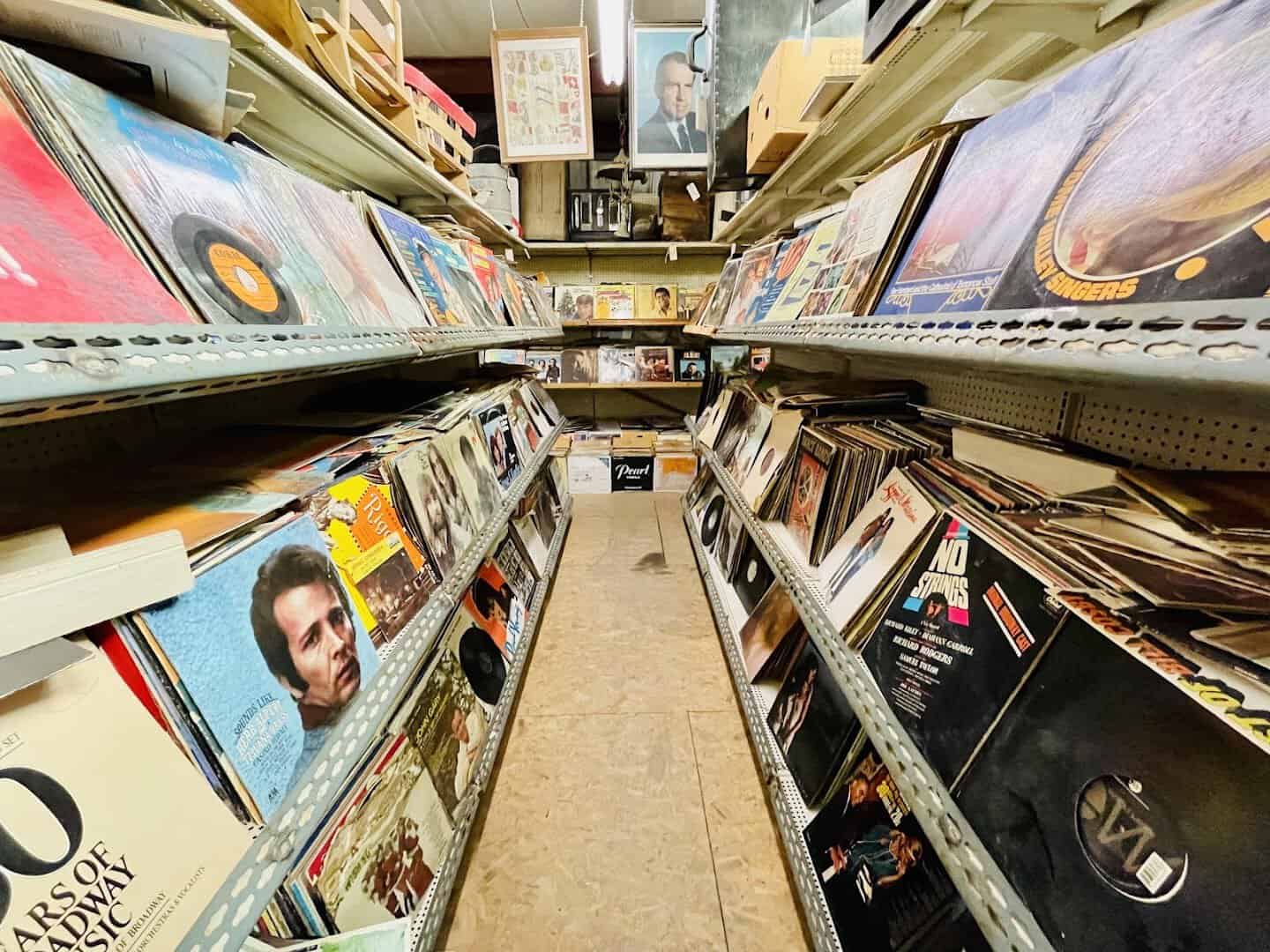 An aisle of thousands of vintage vinyl records at The Whoopee Bowl Antique Mall in Canutillo, Texas