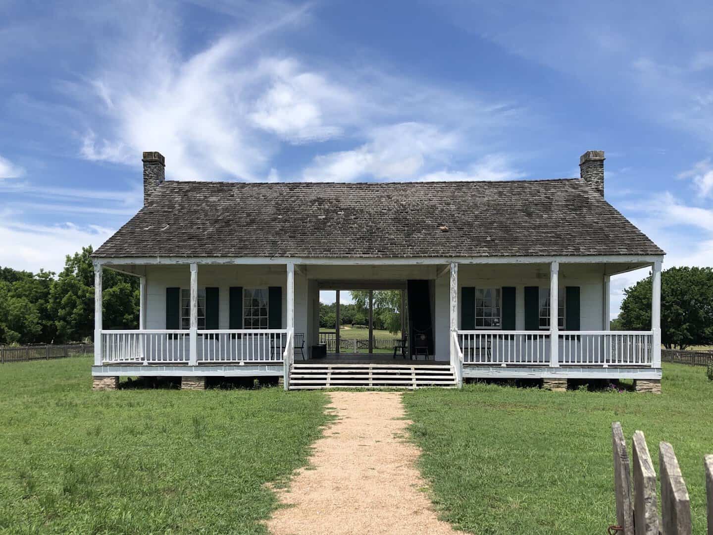 Historic white porch farmhouse at Washington-on-the-Brazos State Historic Site in Texas