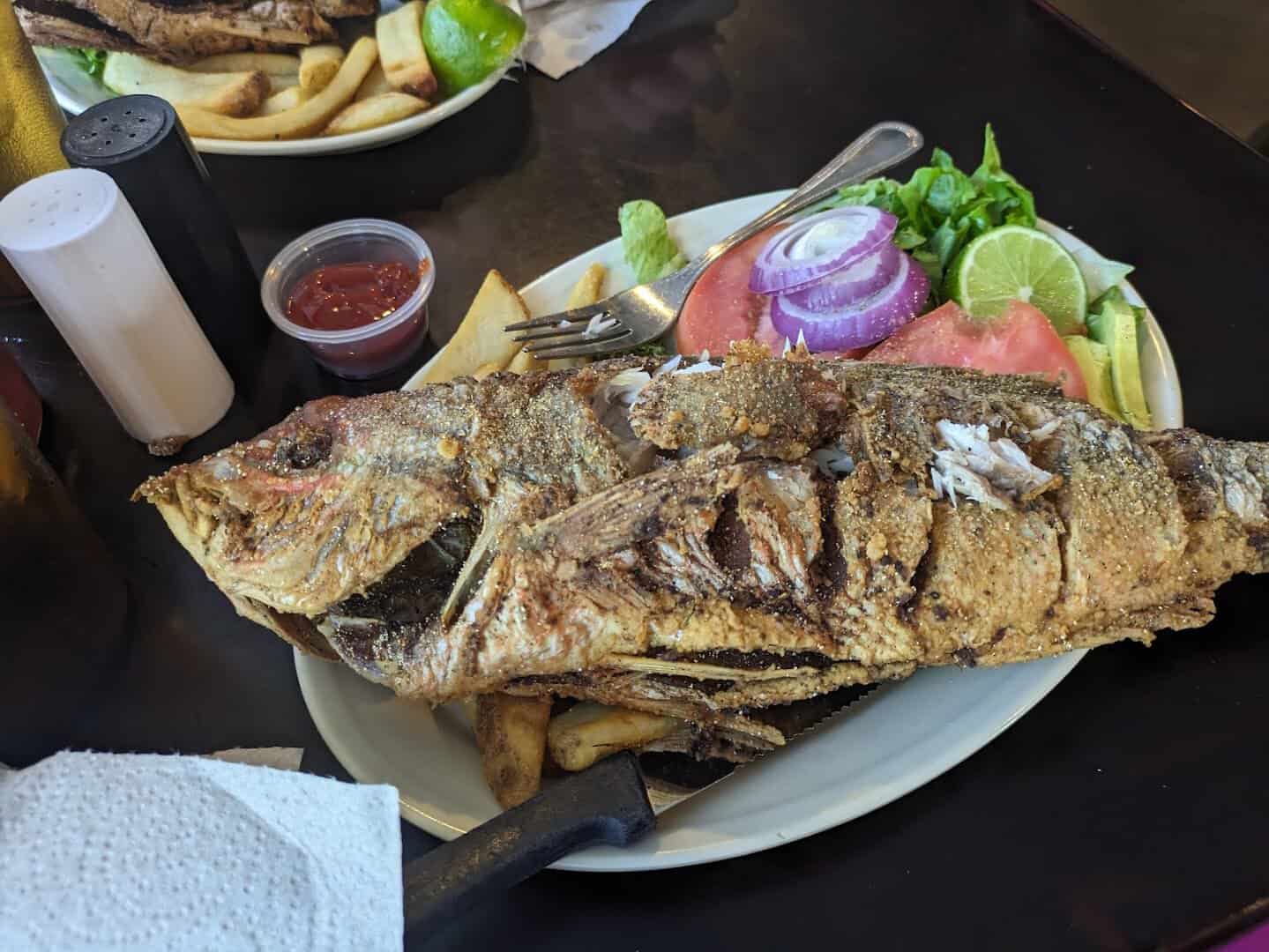Whole fried fish platter with fries and salad at Fish Shack in Plano, Texas