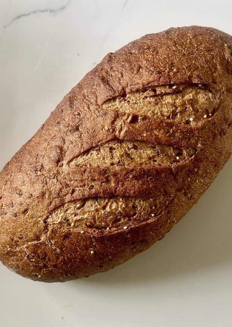 A dark whole-grain sourdough loaf at Artisana Bread in Houston, Texas