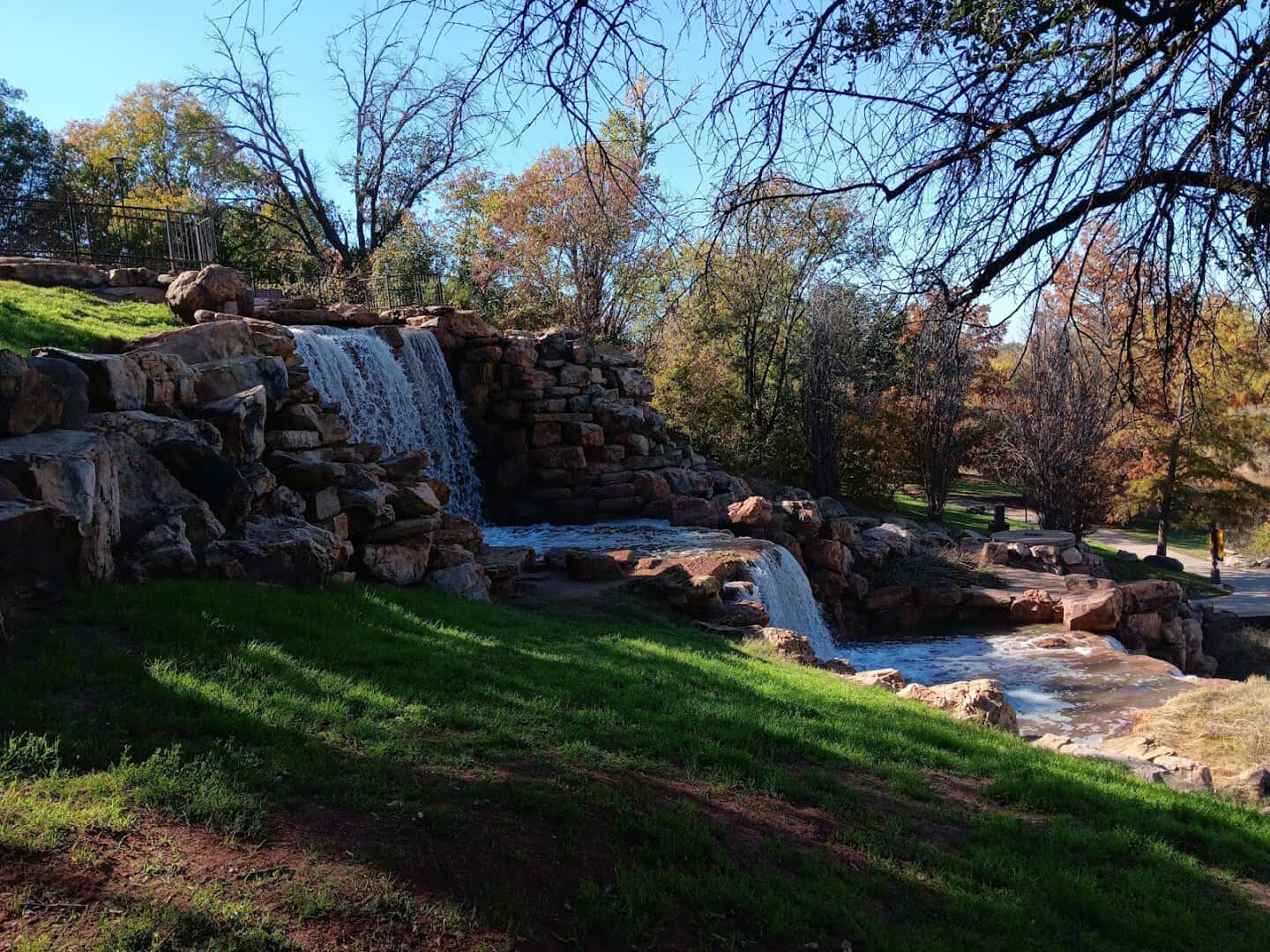 The Wichita Falls waterfall framed by fall foliage at Lucy Park