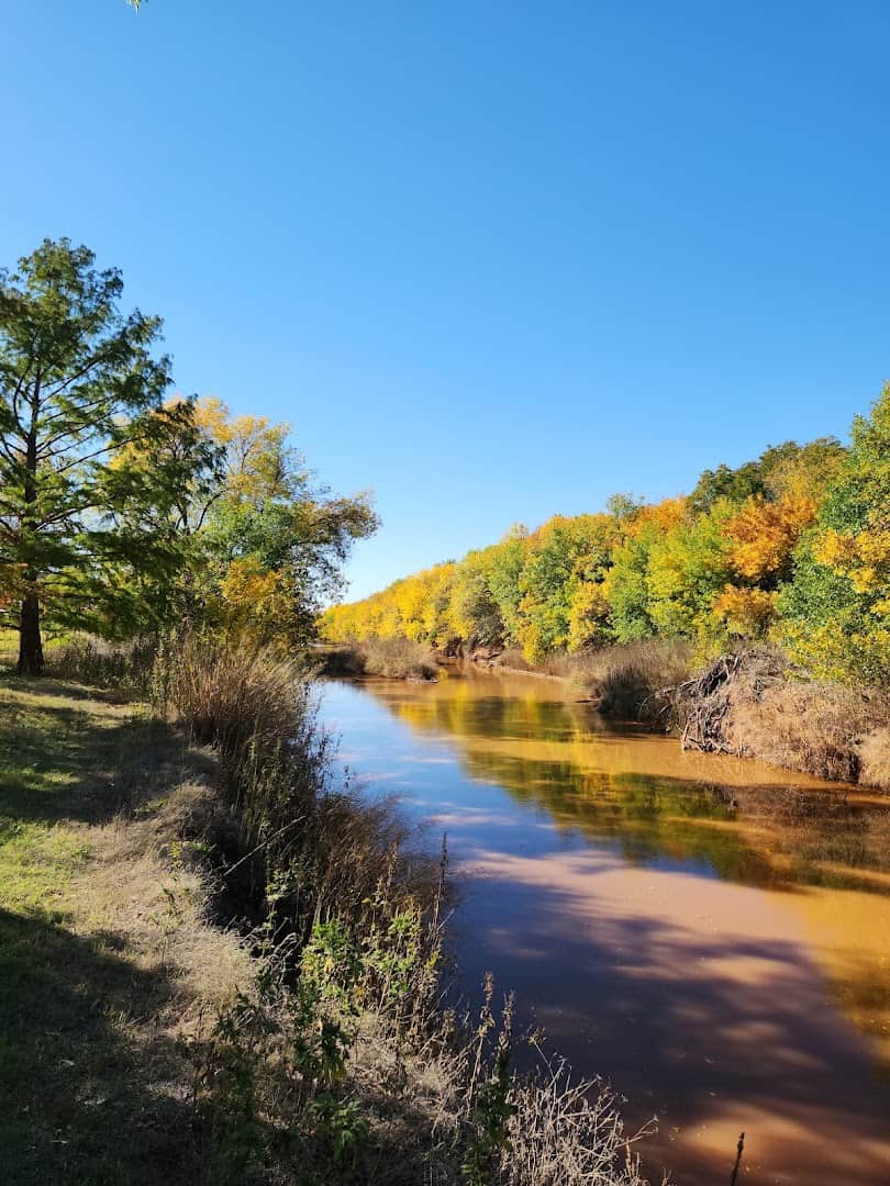 The Wichita River lined with autumn trees at Lucy Park in Wichita Falls