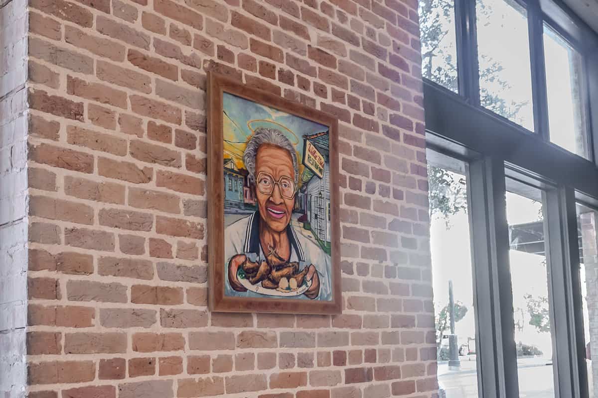 Portrait of Willie Mae Seaton on the exposed brick wall inside Willie Mae's Scotch House in New Orleans, Louisiana