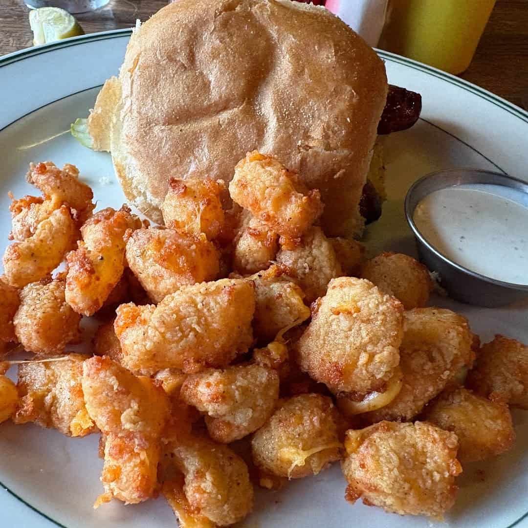 Bratwurst sandwich with fried cheese curds in Madison, Wisconsin