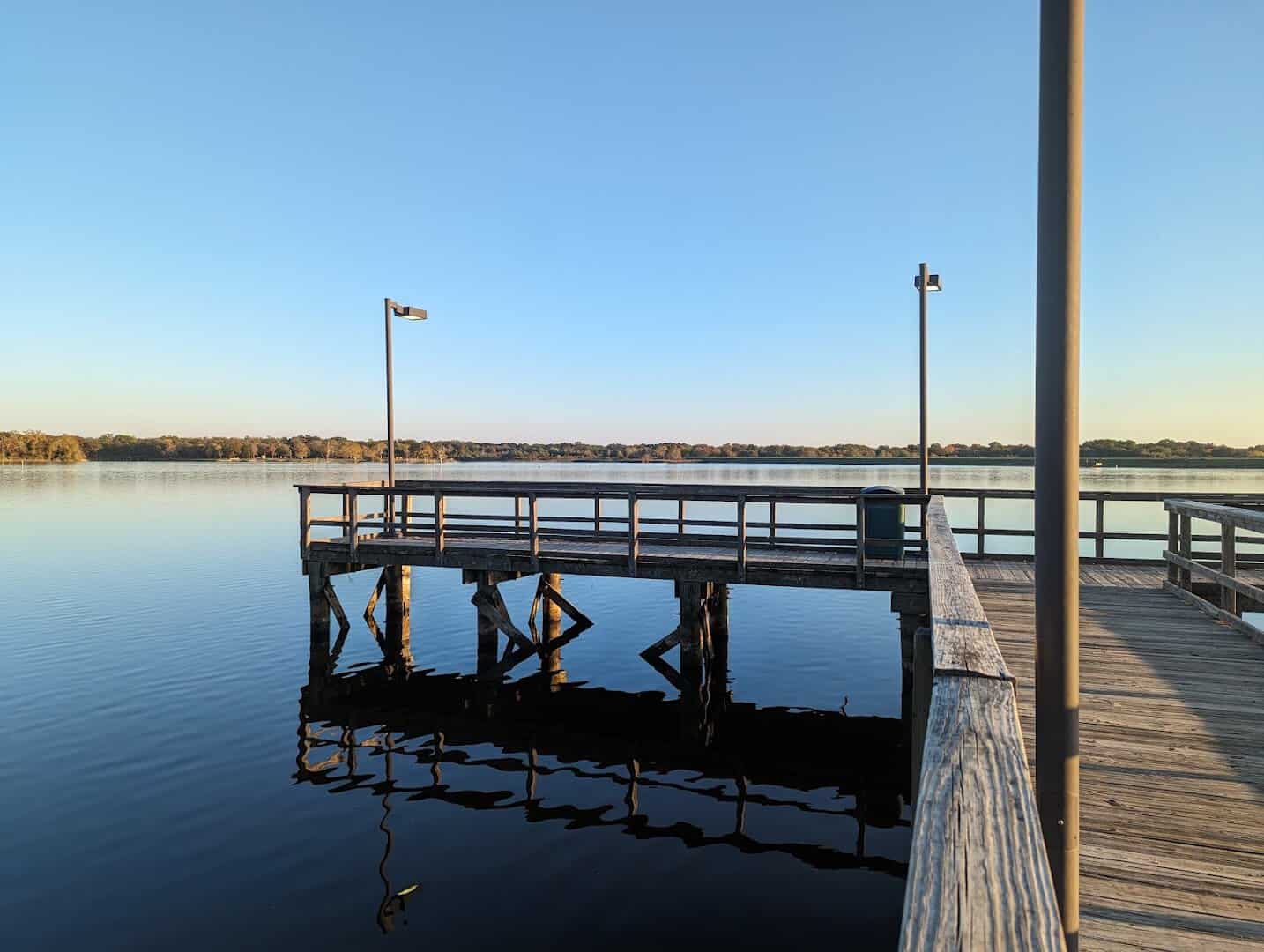 Wooden fishing pier at sunrise on the lake at Purtis Creek State Park