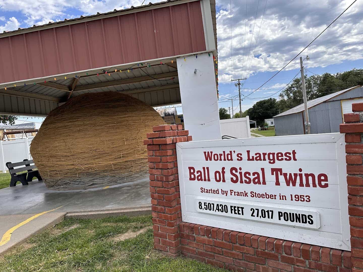 The World's Largest Ball of Twine and its sign in Cawker City, Kansas
