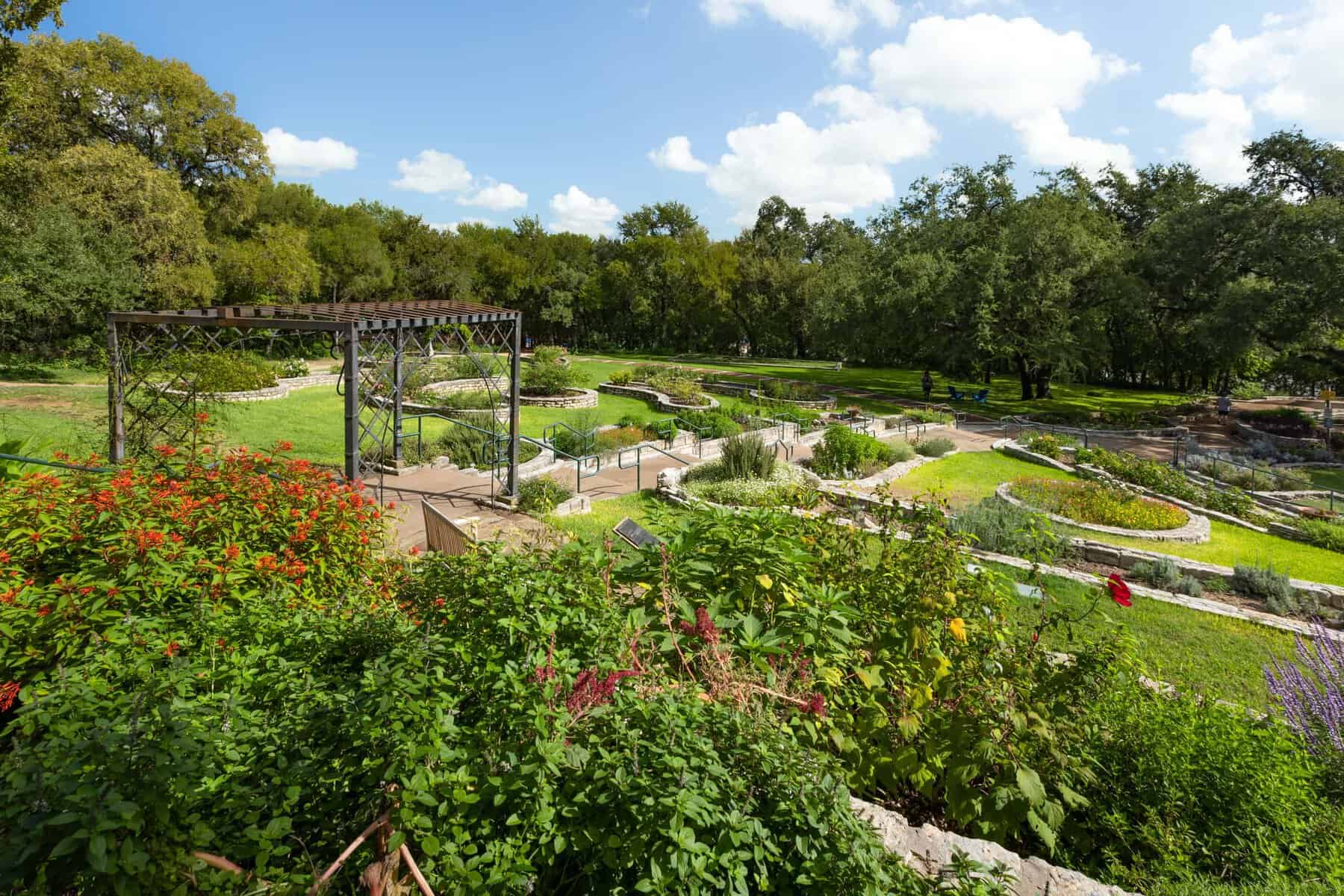 Formal flower beds and pergola at Zilker Botanical Garden in Austin, Texas