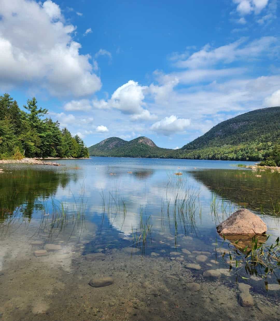 Jordan Pond and the Bubbles reflected in calm water at Acadia National Park, Maine