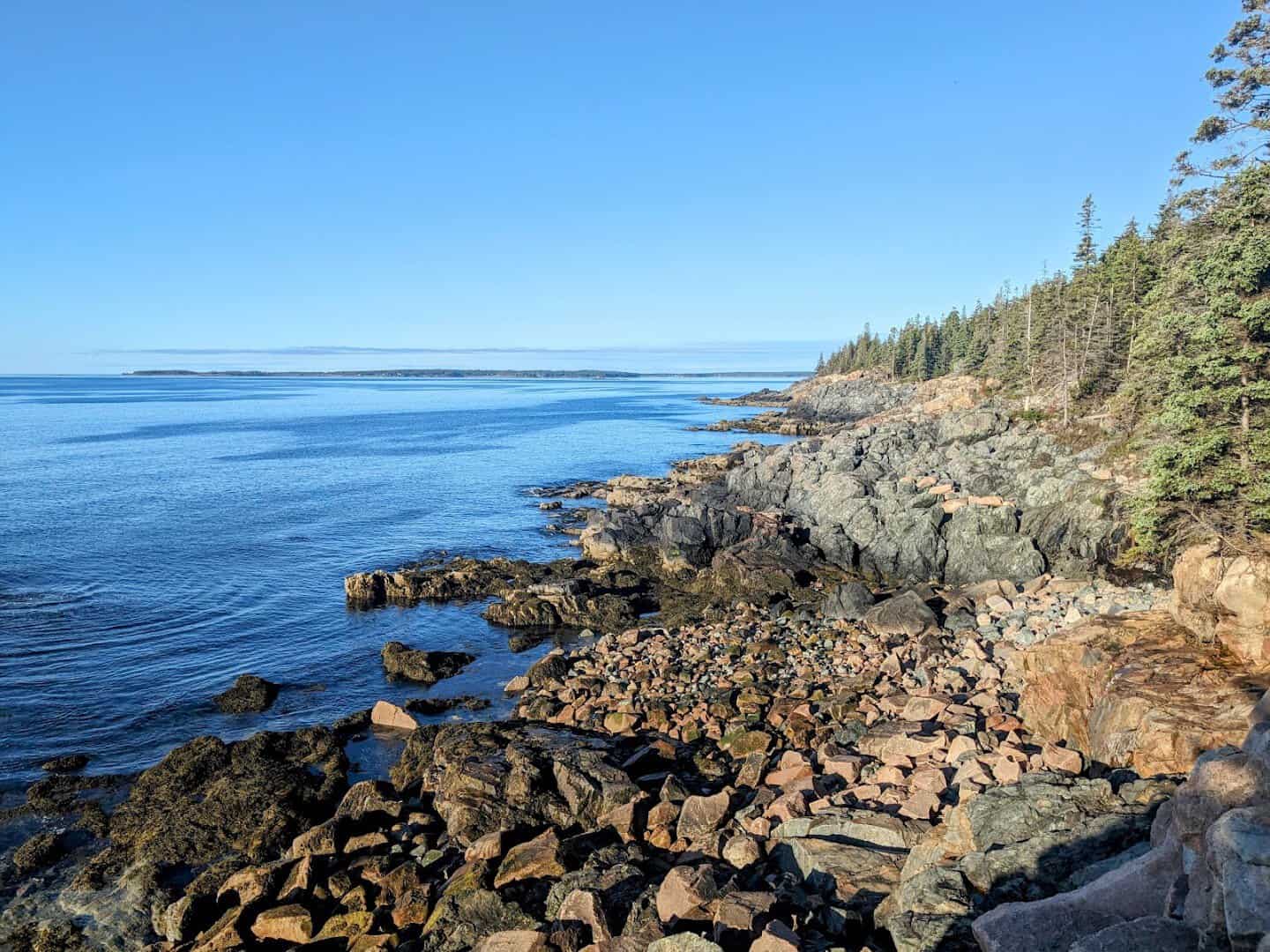 Pink granite ledges meeting the blue Atlantic along the shore of Acadia National Park, Maine