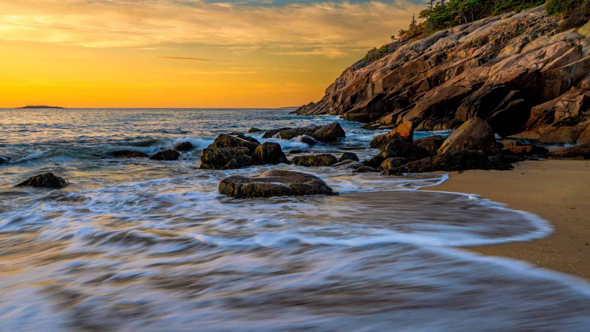Sunset over the rocky shore of Sand Beach in Acadia National Park, Maine