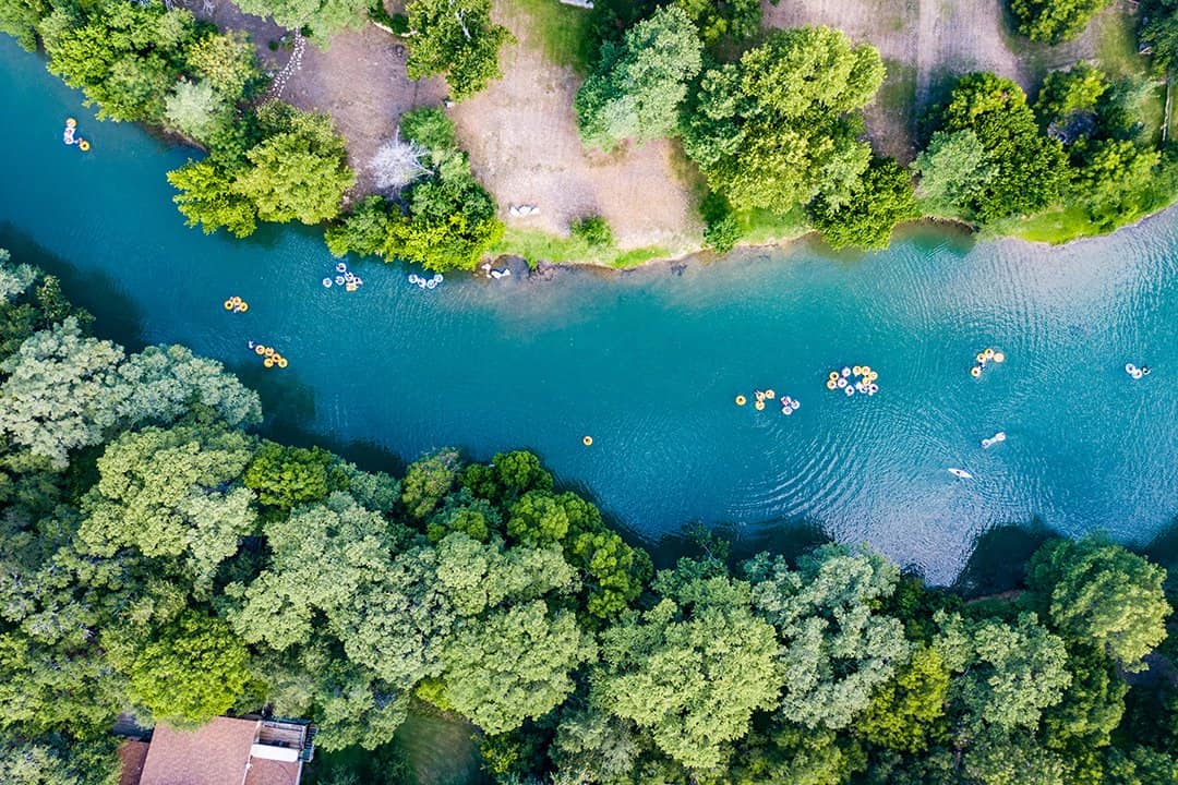 Aerial view of tubers floating the clear Guadalupe River below Canyon Lake