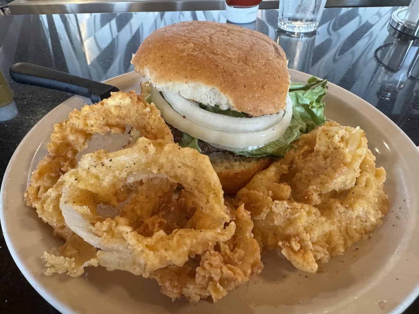 A burger with hand-battered onion rings at the Airport Diner in Fredericksburg, Texas