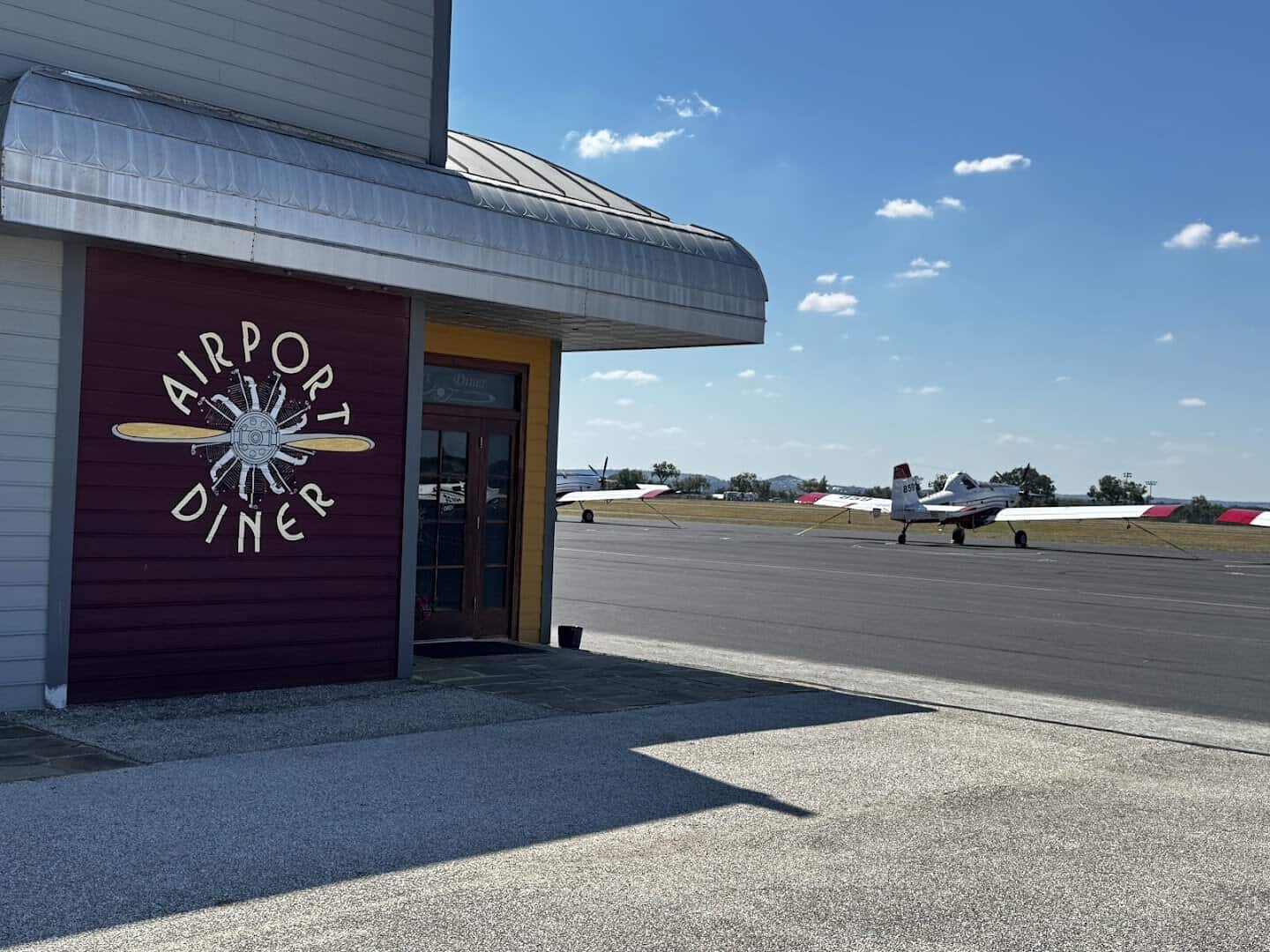 The airport hangar and Airport Diner sign with planes in Fredericksburg, Texas