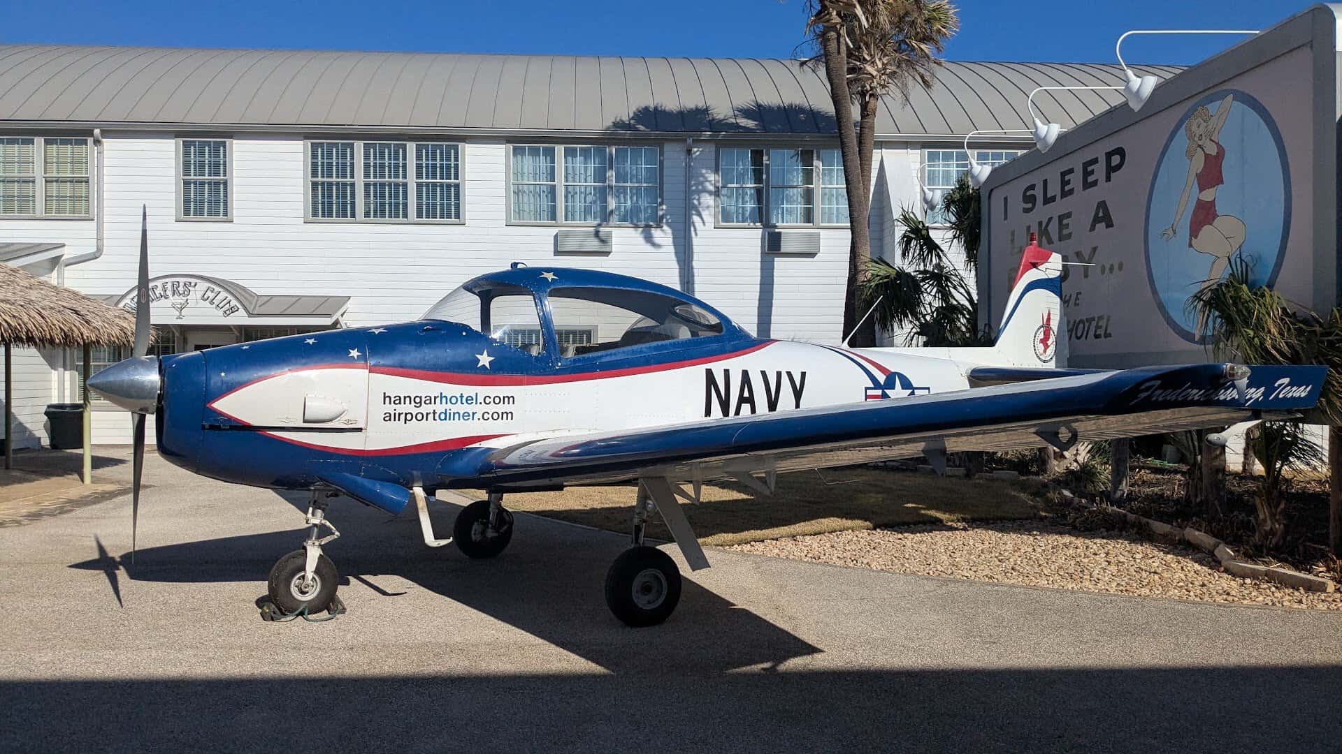 A vintage Navy plane parked on the ramp outside the Airport Diner in Fredericksburg, Texas