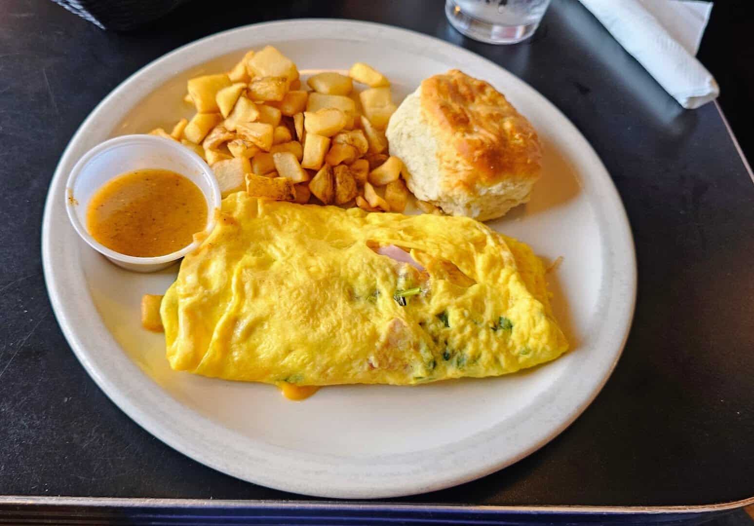 An omelet with a fresh biscuit and breakfast potatoes at the Airport Diner in Fredericksburg, Texas