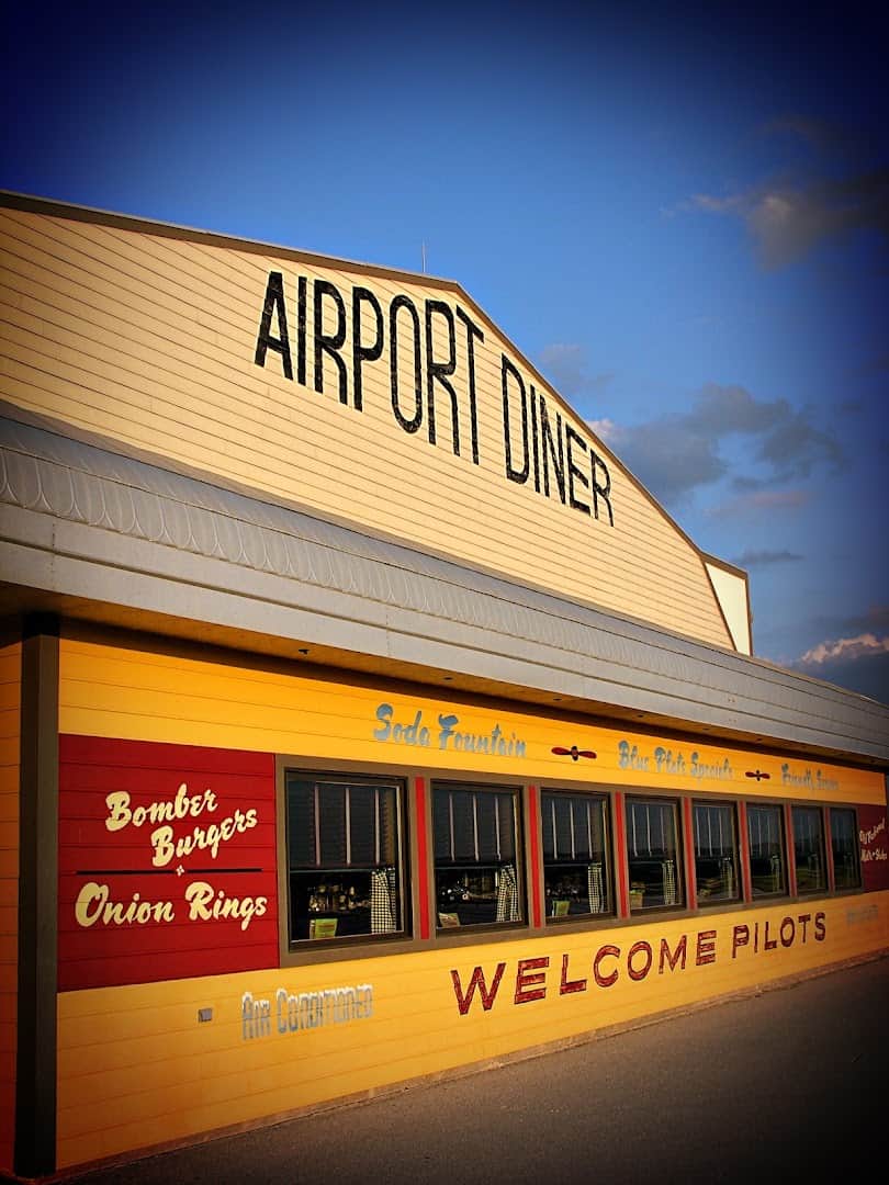 The retro Airport Diner sign lit at dusk in Fredericksburg, Texas