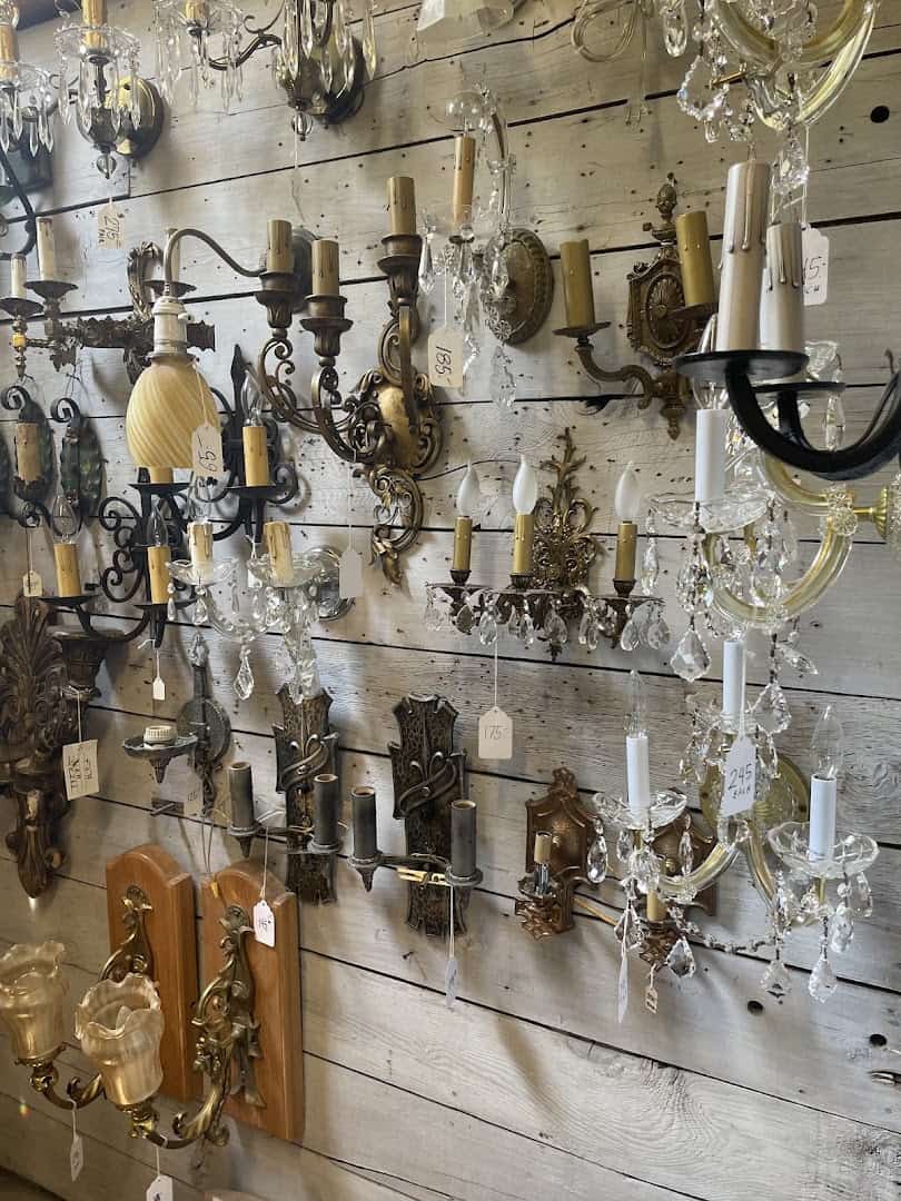 Antique chandeliers and light fixtures hanging at Old Home Supply House in Fort Worth