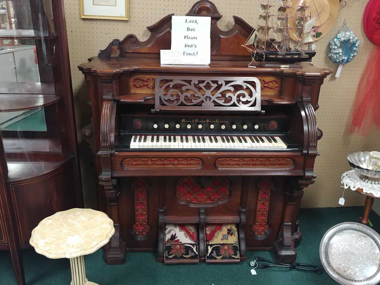 Antique pump organ for sale in a booth at The Antique Gallery of Houston in Spring Texas
