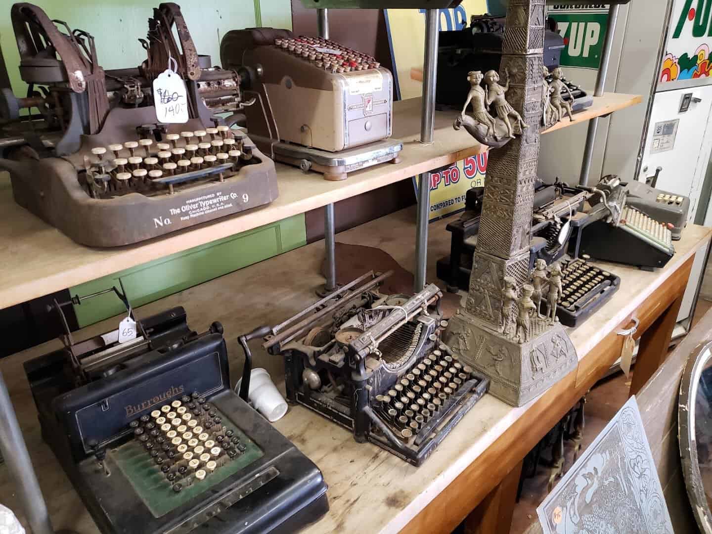 Antique typewriters and adding machines with vintage 7UP advertising at Old Home Supply House in Fort Worth