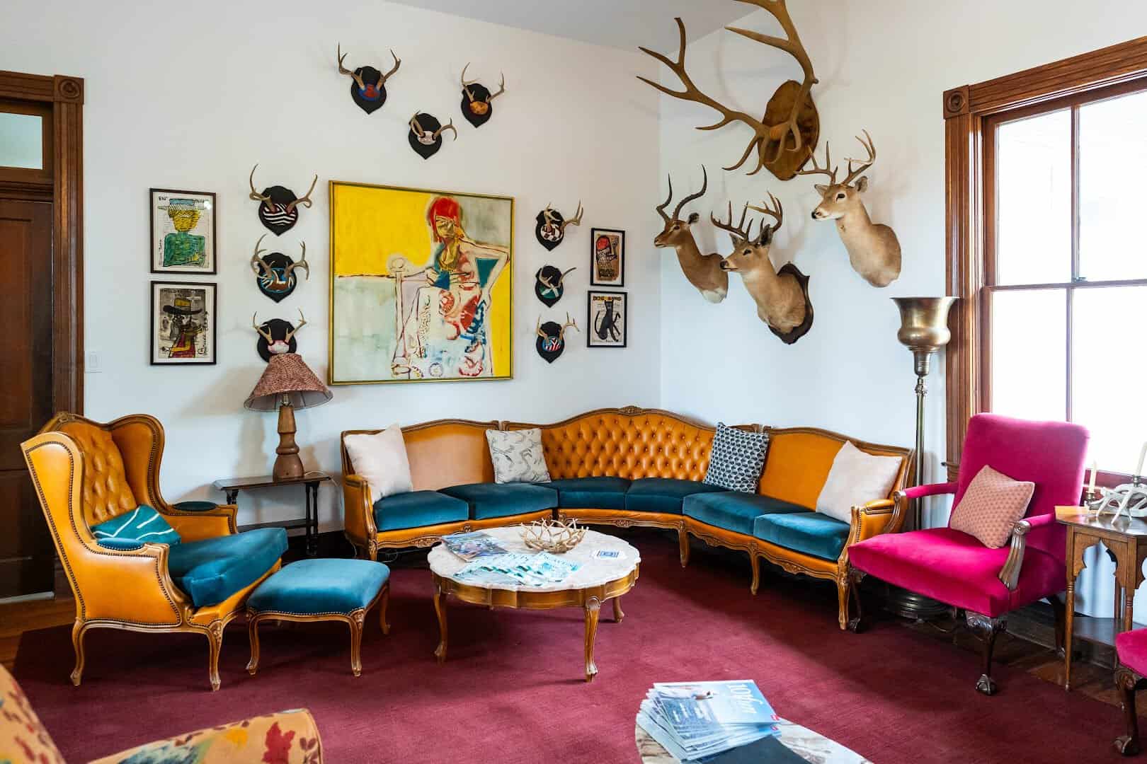 Lounge with antler mounts inside the 1901 main inn at The Antlers Inn