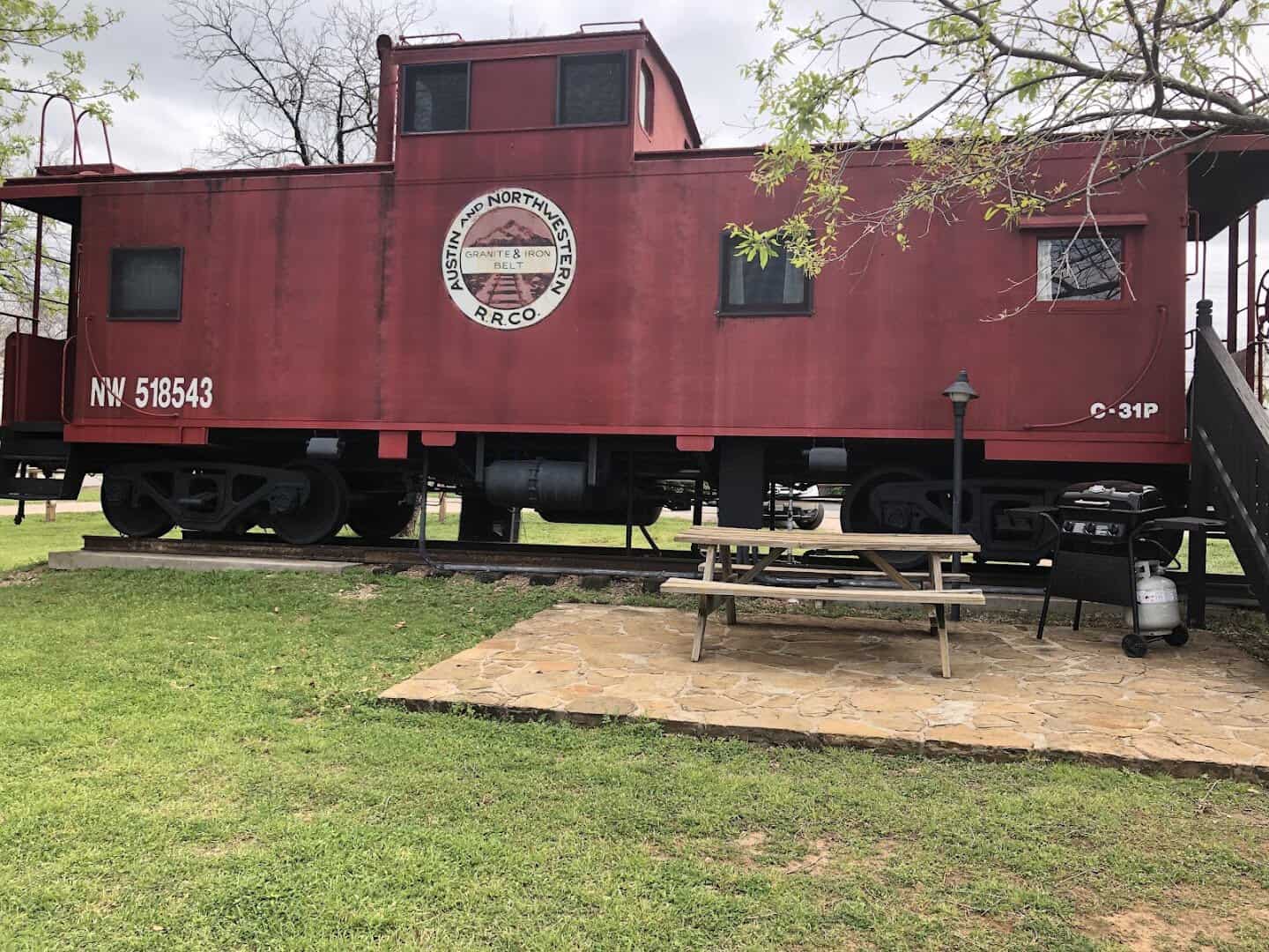 Red caboose with its rooftop cupola at The Antlers Inn in Kingsland
