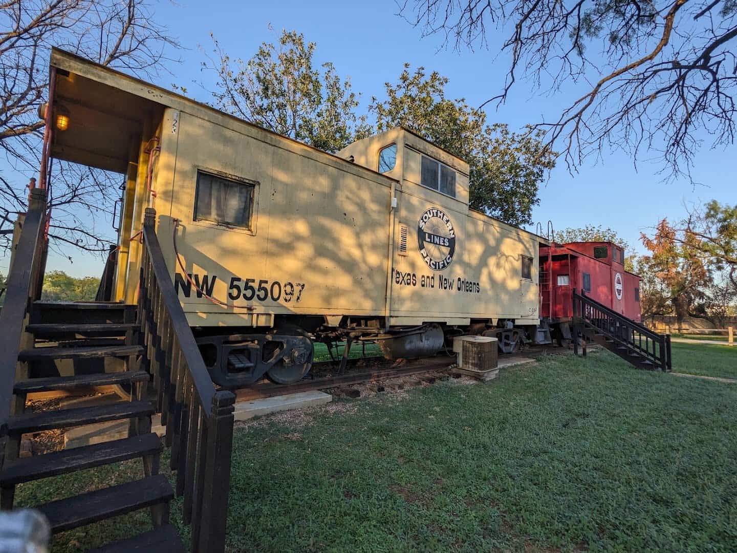 Yellow and red cabooses on the grounds of The Antlers Inn