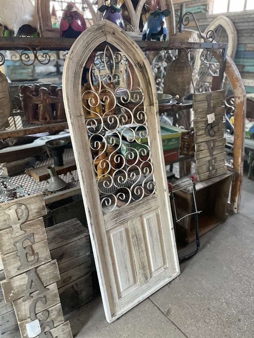 Salvaged arched window frame and architectural pieces at Old Home Supply House in Fort Worth