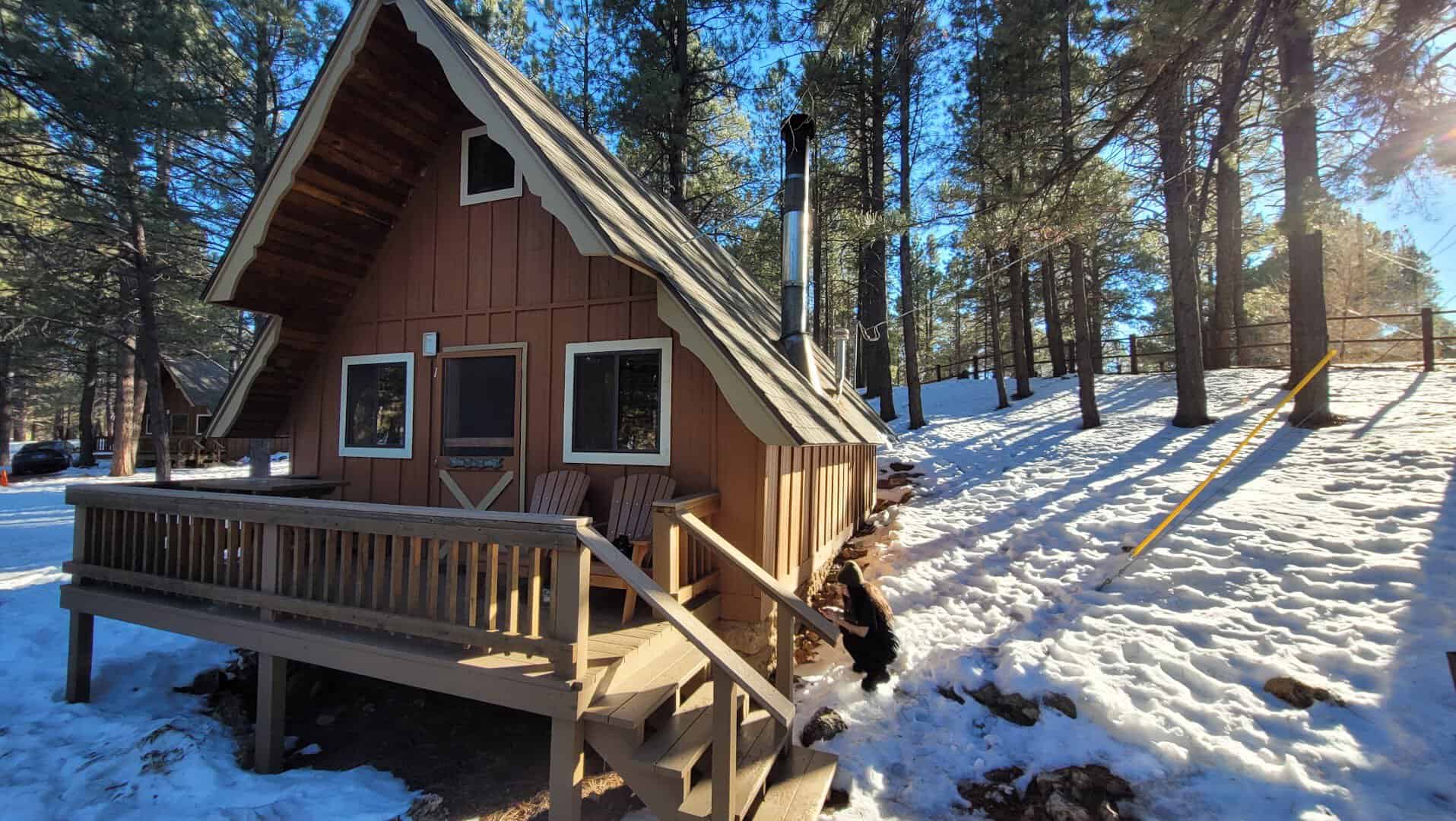 A-frame wood cabin in a snowy pine forest, Arizona Mountain Inn & Cabins, Flagstaff, Arizona
