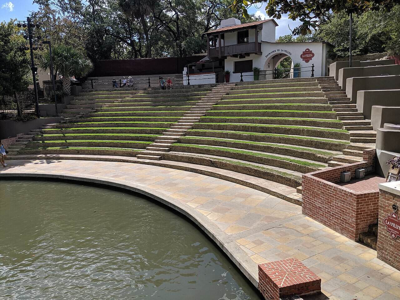 Grass terraced seating of the Arneson River Theatre beside the San Antonio River