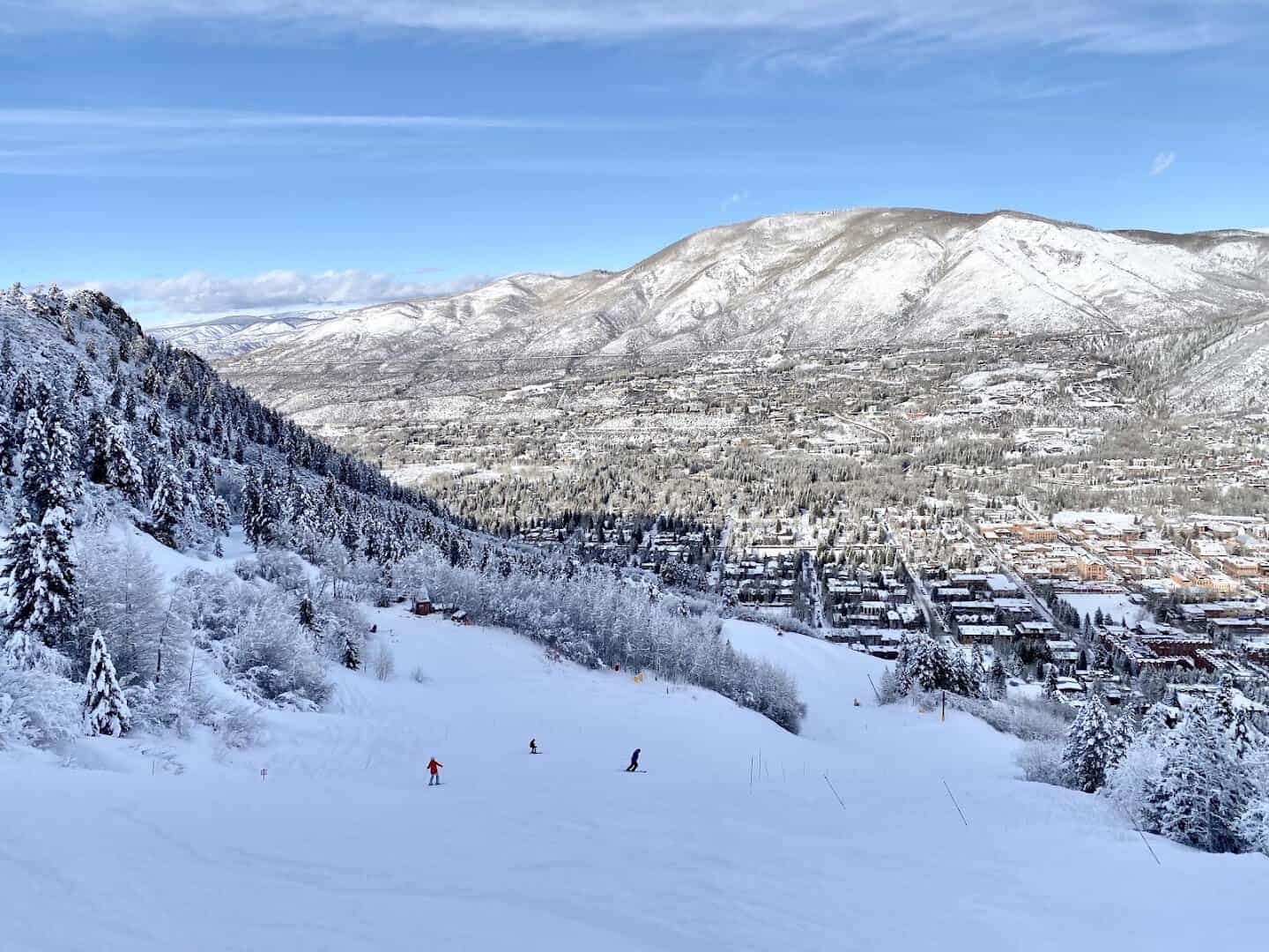 Snow-covered Aspen Mountain ski runs above the town of Aspen, Colorado