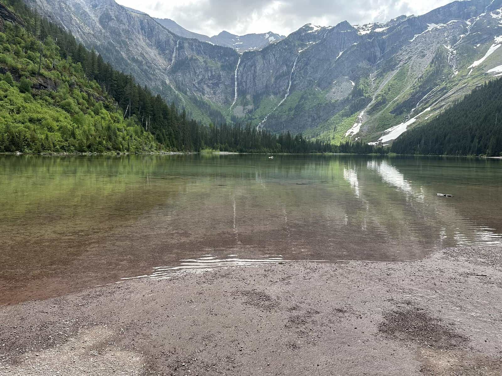 Avalanche Lake ringed by cliffs and waterfalls in Glacier National Park, Montana