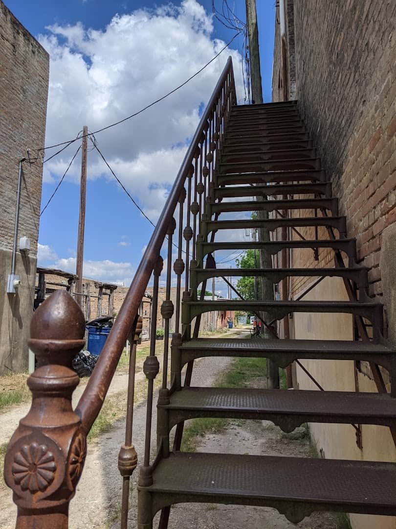 Old iron staircase against a brick wall in downtown Bartlett Texas