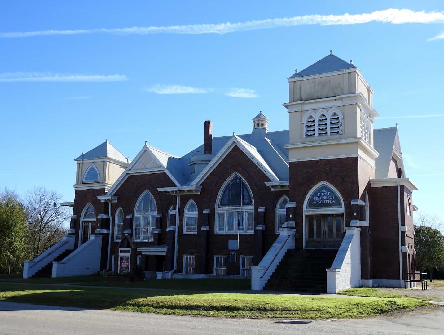 Twin towered red brick church from Bartlett's cotton boom years in Bartlett Texas