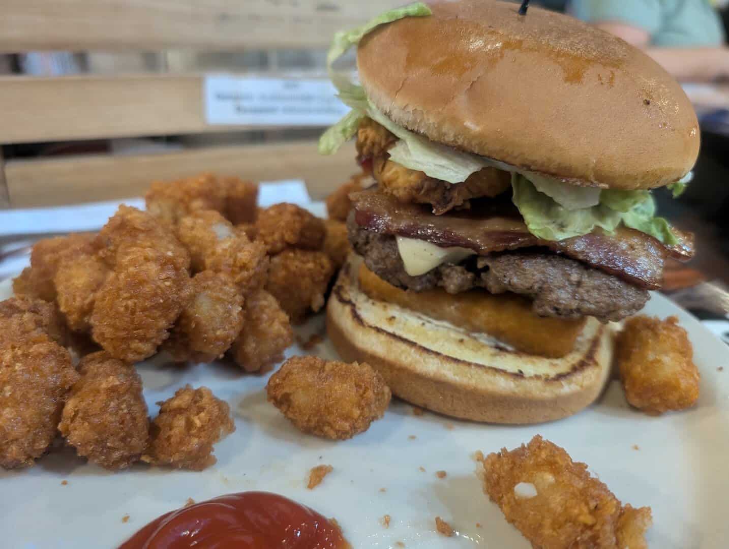 A loaded Bebo's burger with bacon and cheese served with tater tots at Bebo's and Kathy's Cafe