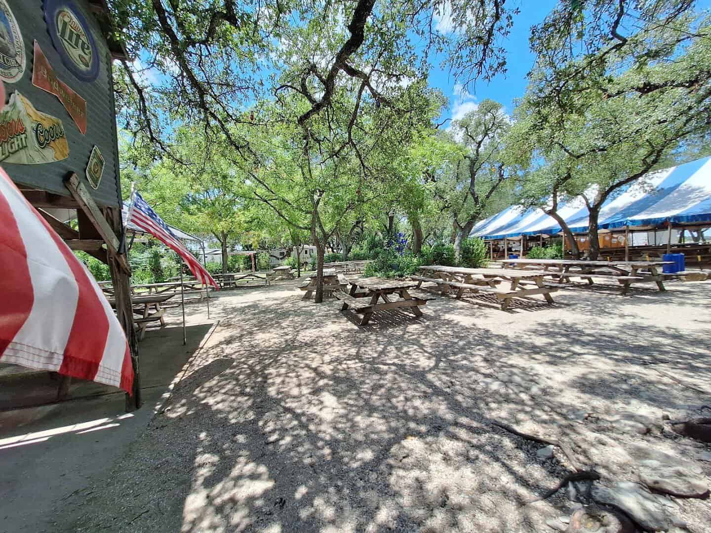 Outdoor biergarten under oak trees at Walburg German Restaurant