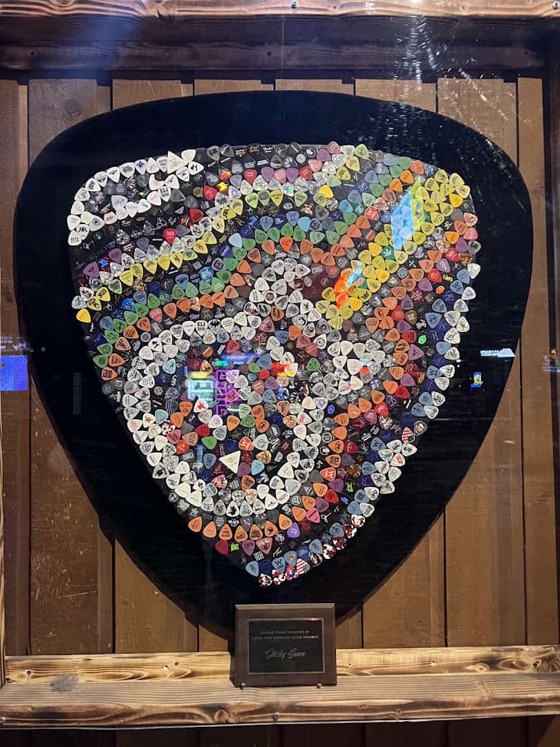 A mosaic of hundreds of signed guitar picks shaped like a giant pick at Billy Bob's Texas in Fort Worth