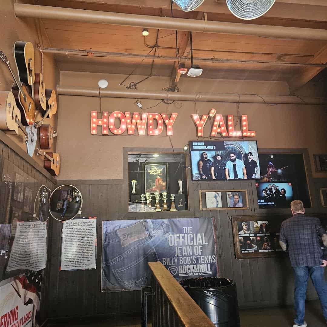 Howdy Y'all sign and country music memorabilia inside Billy Bob's Texas in Fort Worth